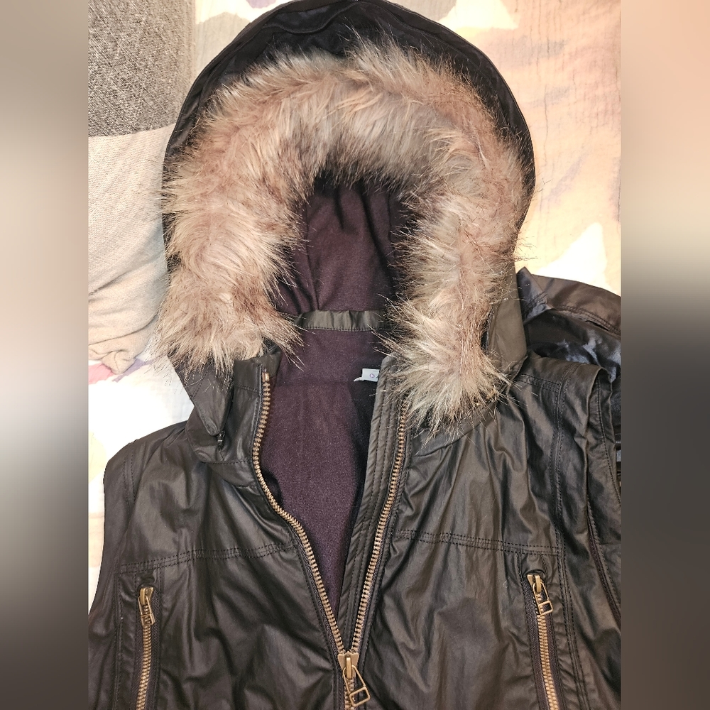 Athleta hoodie vest jacket with a zip on or off fur trim on hood.